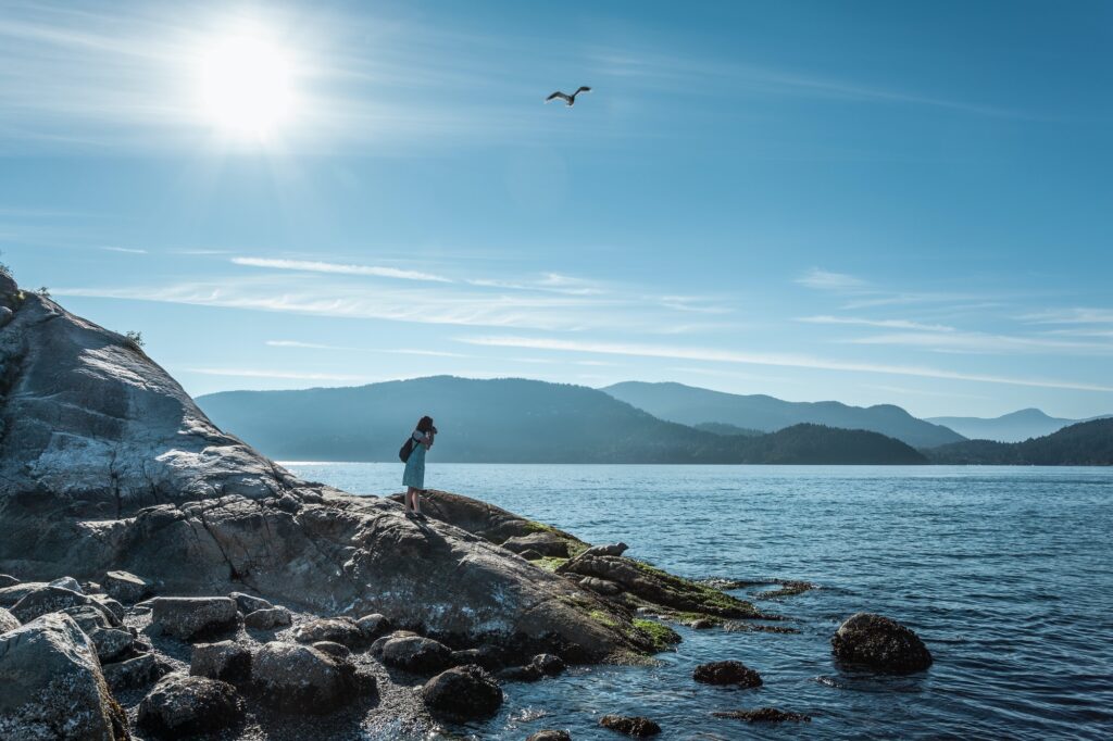 Woman on rocks, Whytecliff Park, British Columbia,Canada